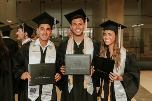 Student-athletes in graduation regalia at spring 2024 commencement. 